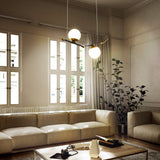 VONN Artisan Chianti 43" Integrated LED Pendant in Antique Brass VAC3122AB over a hotel lobby