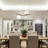 VONN Artisan Chianti 43" Integrated LED Pendant in Antique Brass VAC3122AB over a dining room table