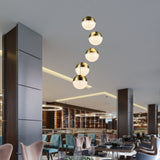 VONN Ravello 5-Light LED Pendant VAC3285BRS in the restaurant setting