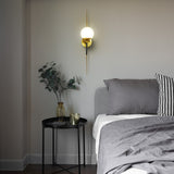 VONN Chianti 30-inch Antique Brass Wall Sconce in the bedroom
