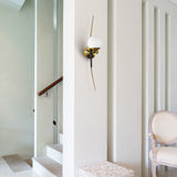 VONN Chianti 30-inch Antique Brass Wall Sconce on white wall