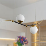 VONN Artisan Chianti 43" Integrated LED Pendant in Antique Brass VAC3122AB hovering in the living room