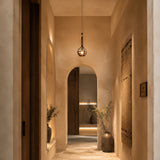 Pendant light installed in a warm modern hallway